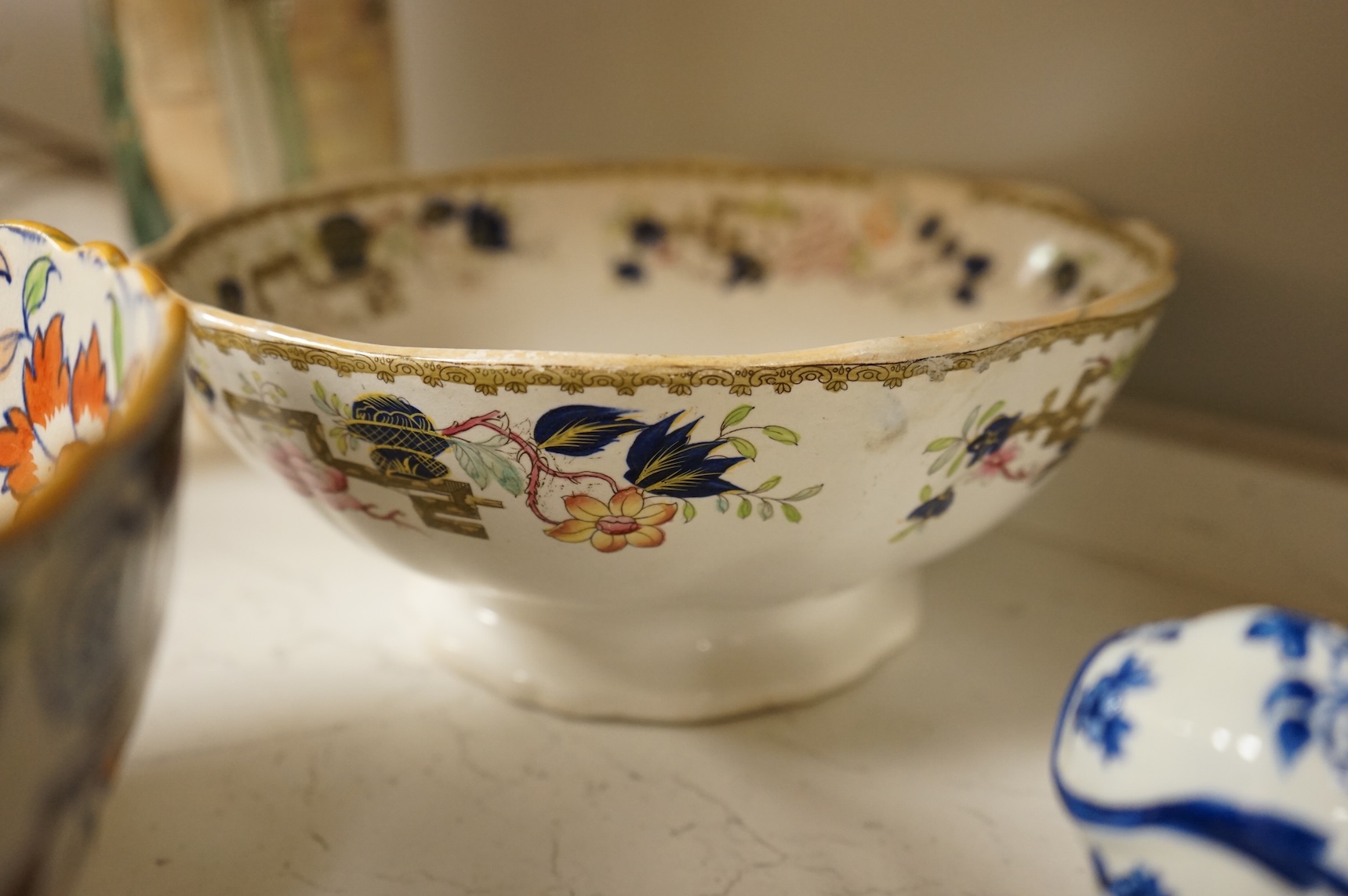 A collection of French, Japanese and English ceramics to include Royal Doulton Dickensware, Imari bowls and a faience glazed cat